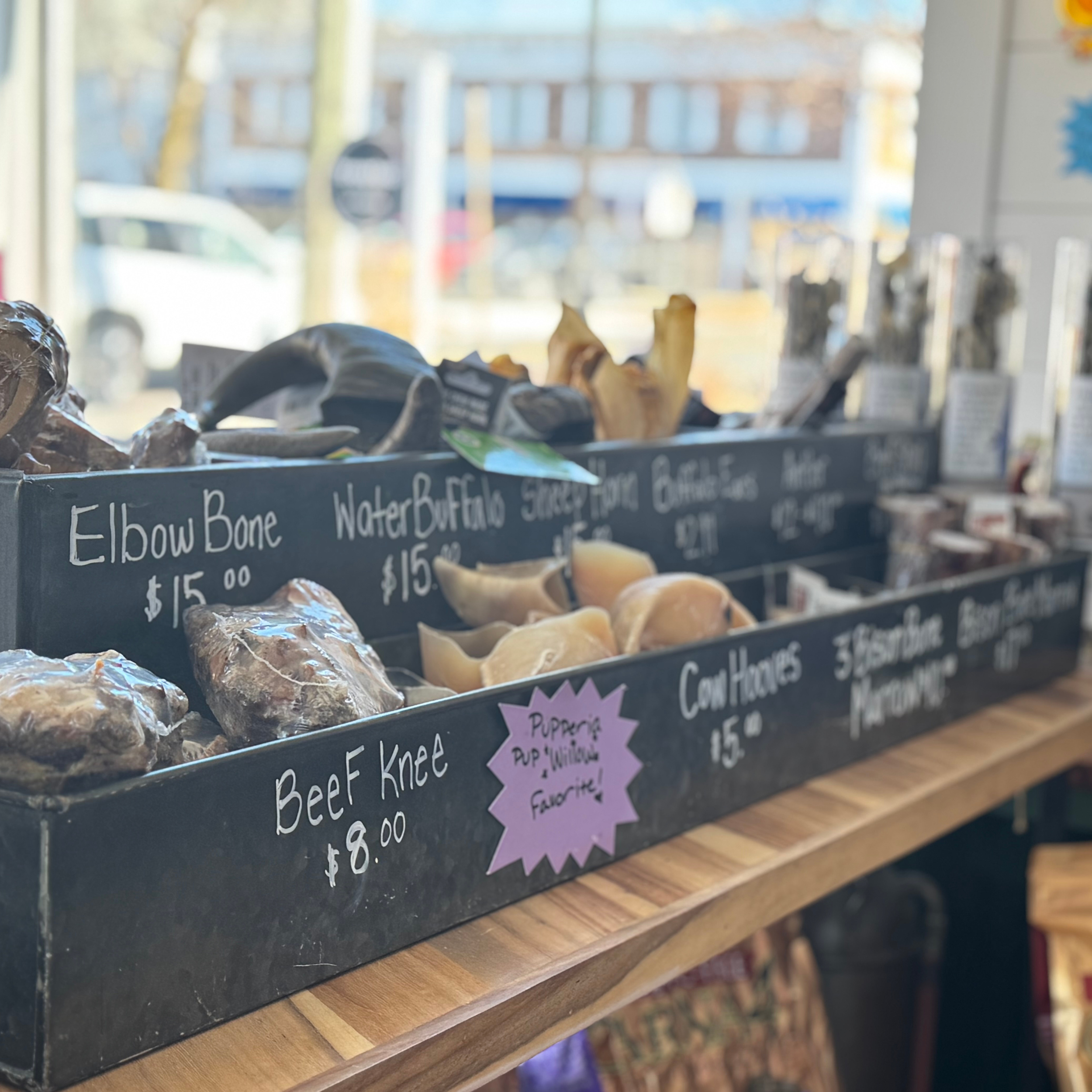Treats bar with bones, hooves, horns and other goodies for dogs to chew on.