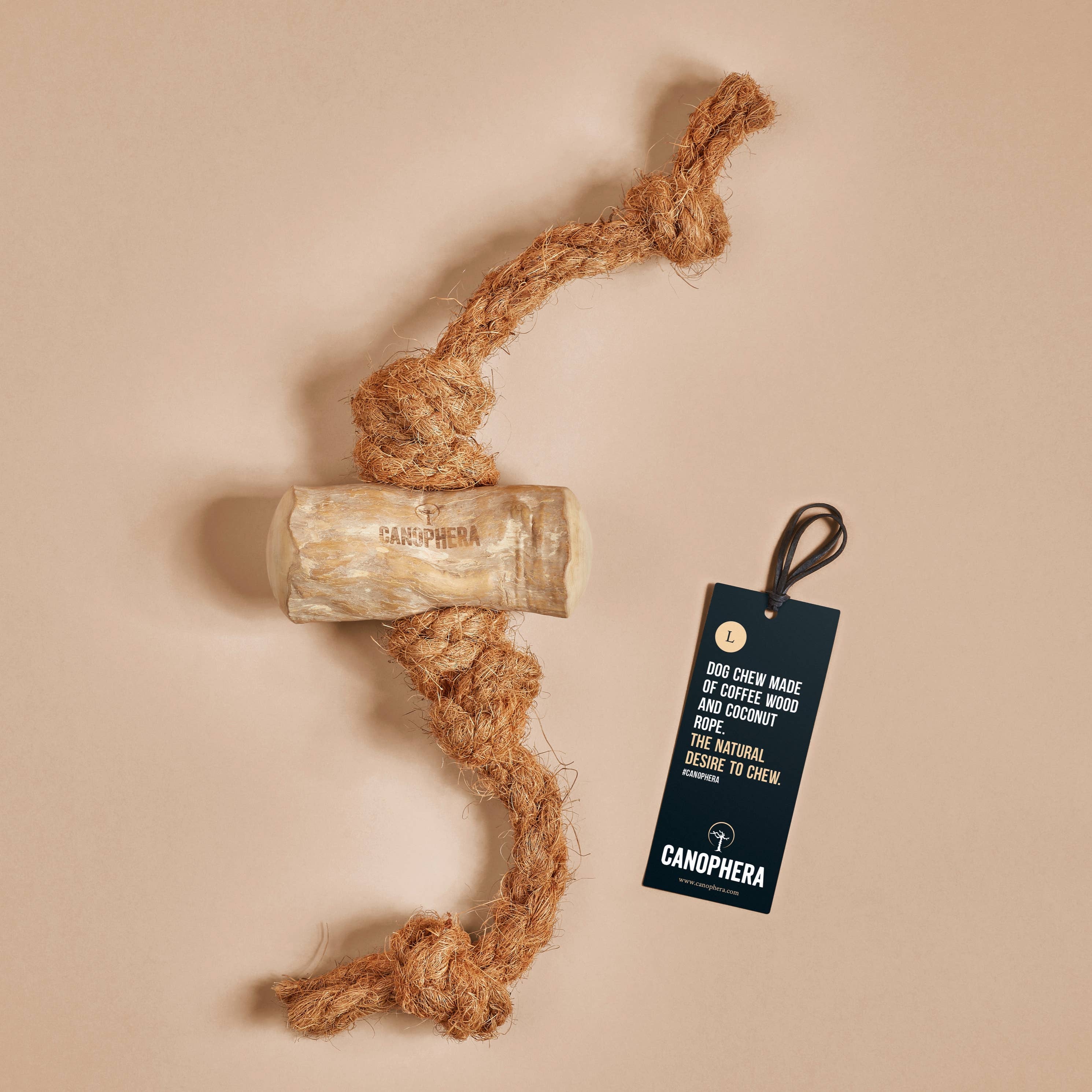 A coconut fiber rope with a chunk of coffee wood in the middle, product tag lying beside it.
