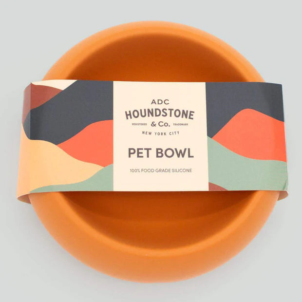 Marigold silicone travel pet bowl on a white background.