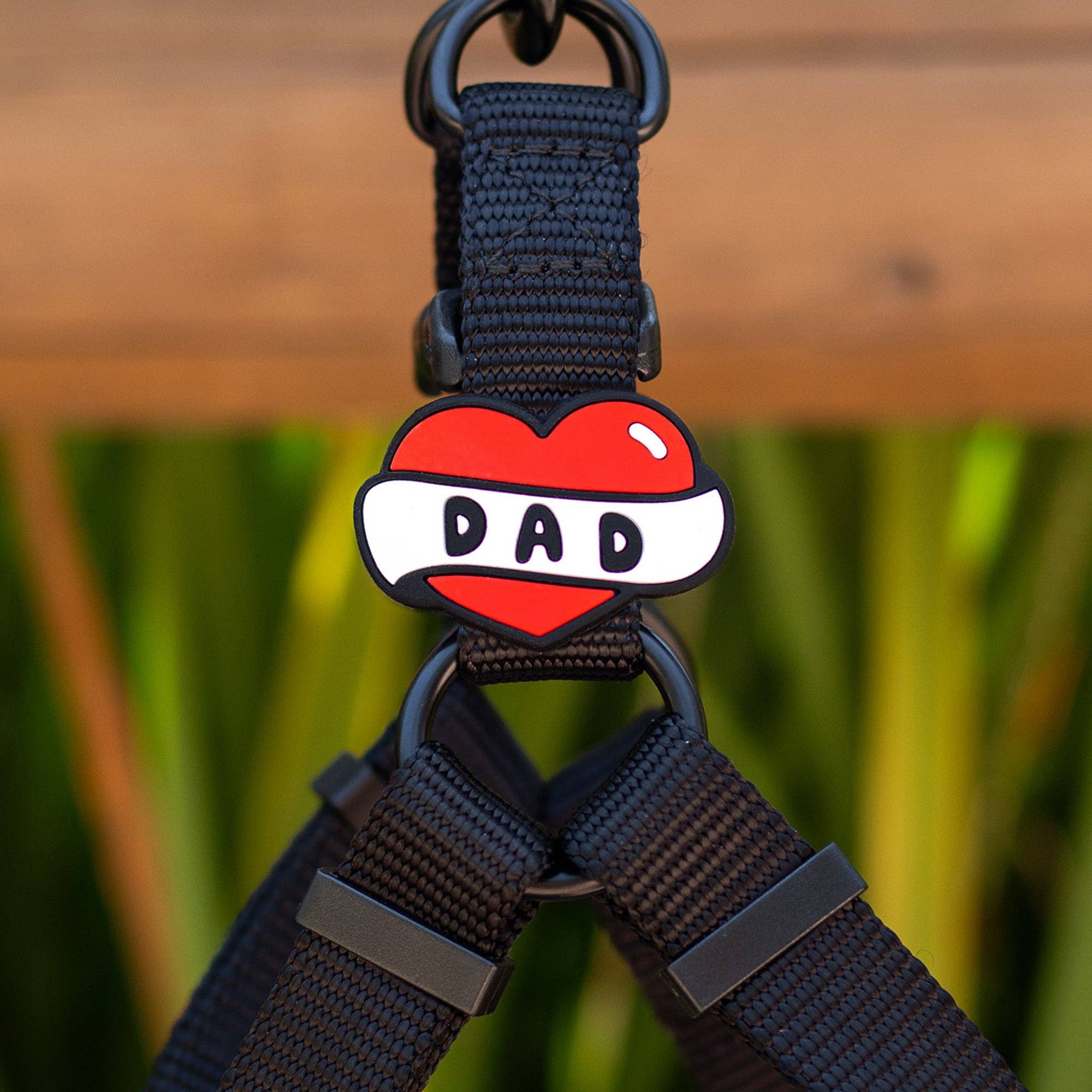 A red heart silicone jiby with "dad" written on a white banner across the heart.