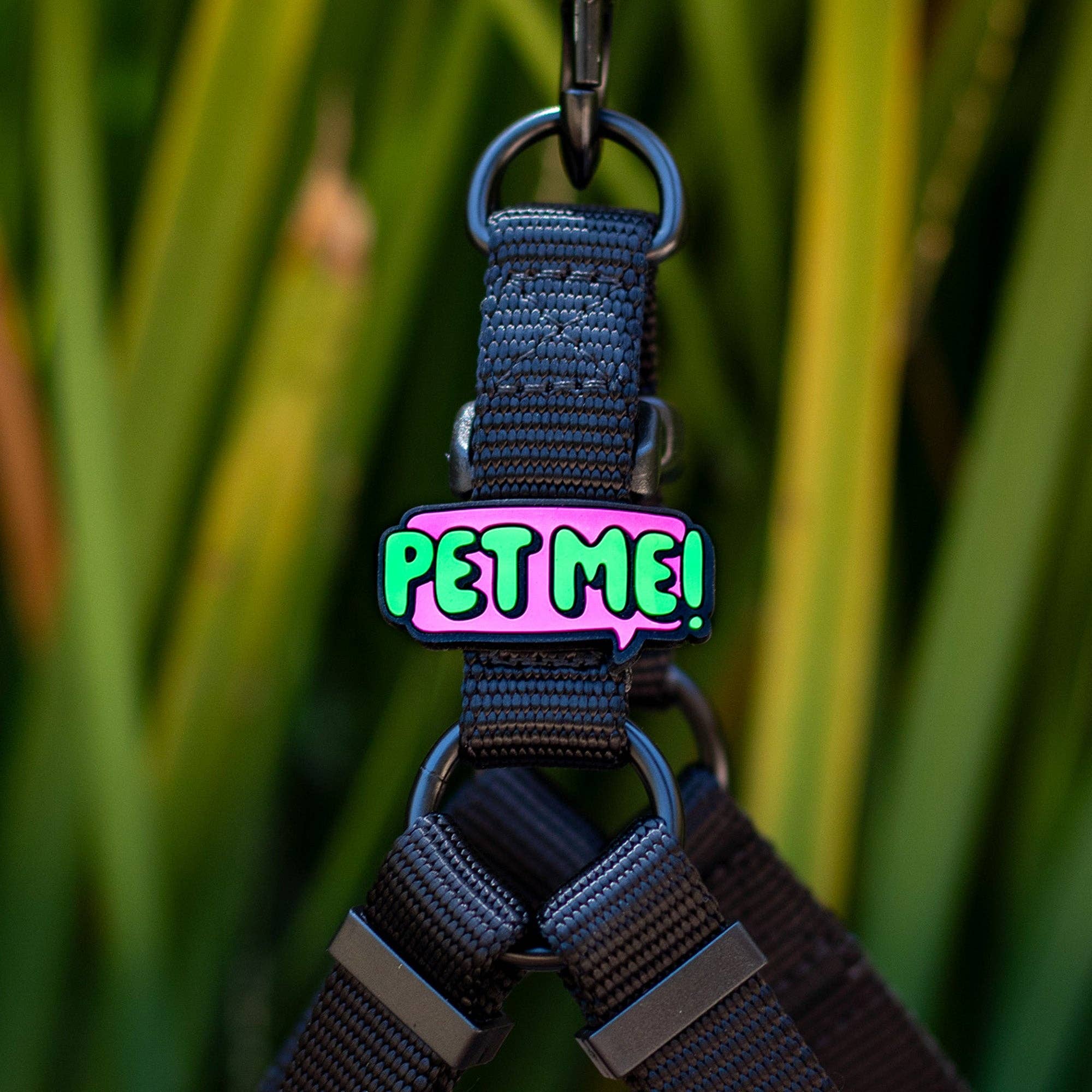 A pink, silicone jiby with "pet me" written in bright green text.