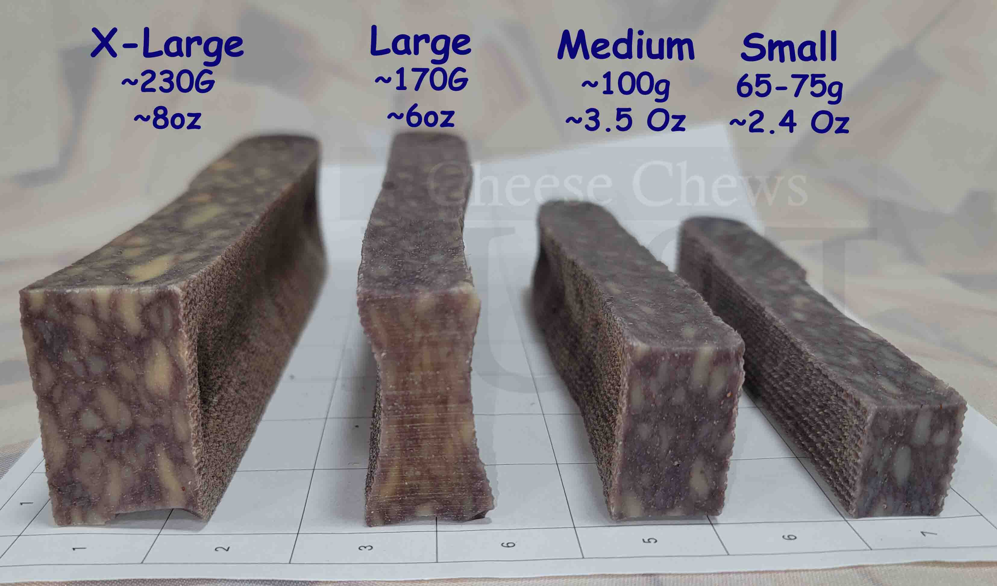 Four dog chew treats of different sizes on a measuring chart with weight labels.