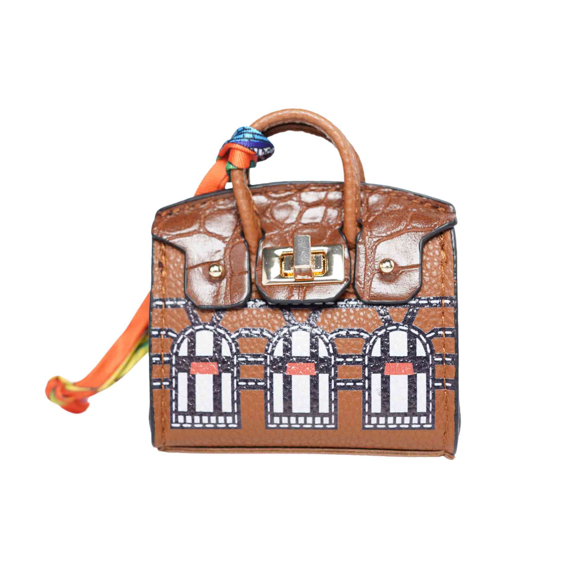 Brown handbag-style dog waste bag dispenser with gold hardware on a white background.