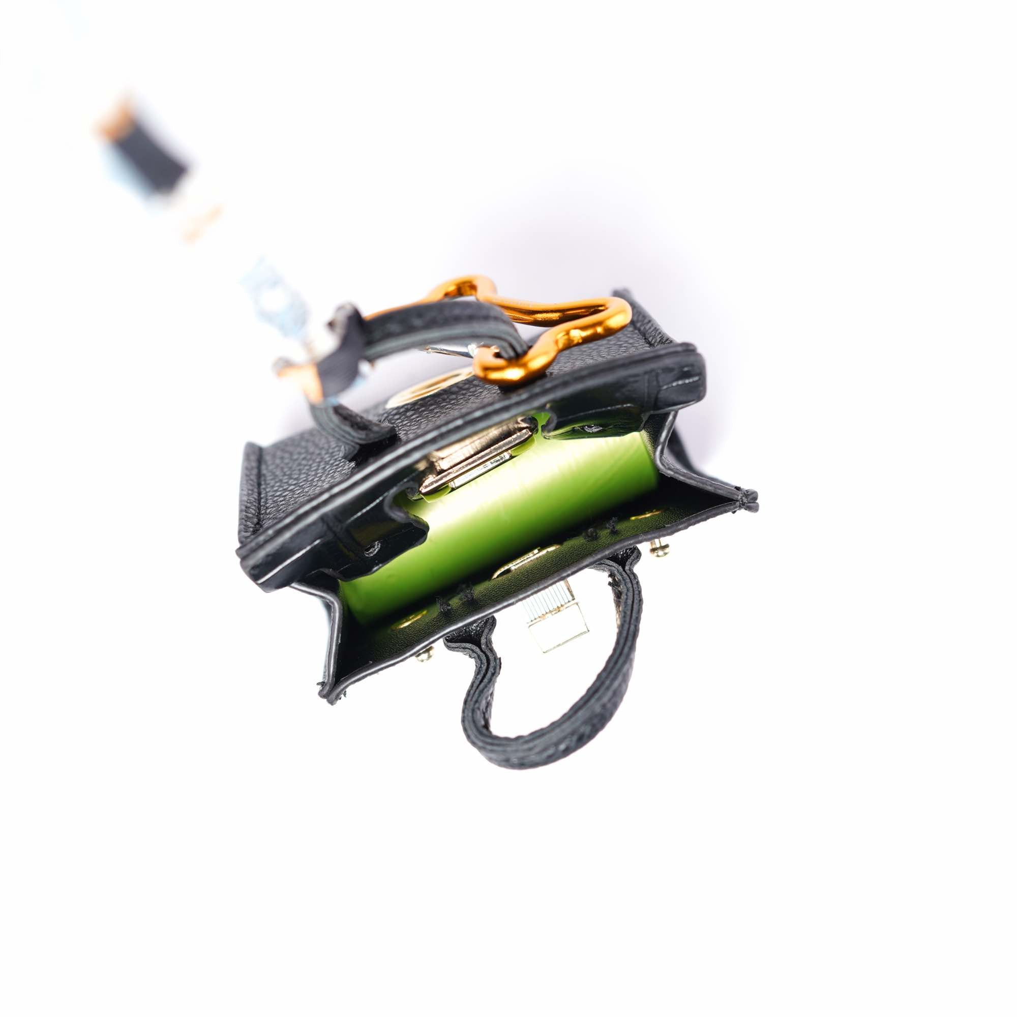 A look at the roll of bags inside the handbag-style dog waste bag dispenser.