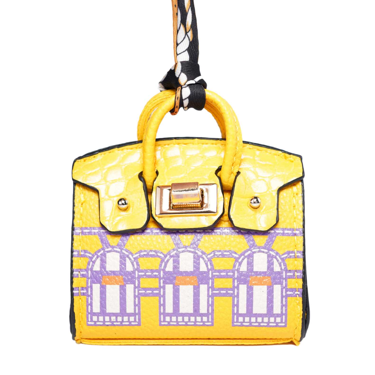 Yellow handbag-style dog waste bag dispenser with gold hardware on a white background.