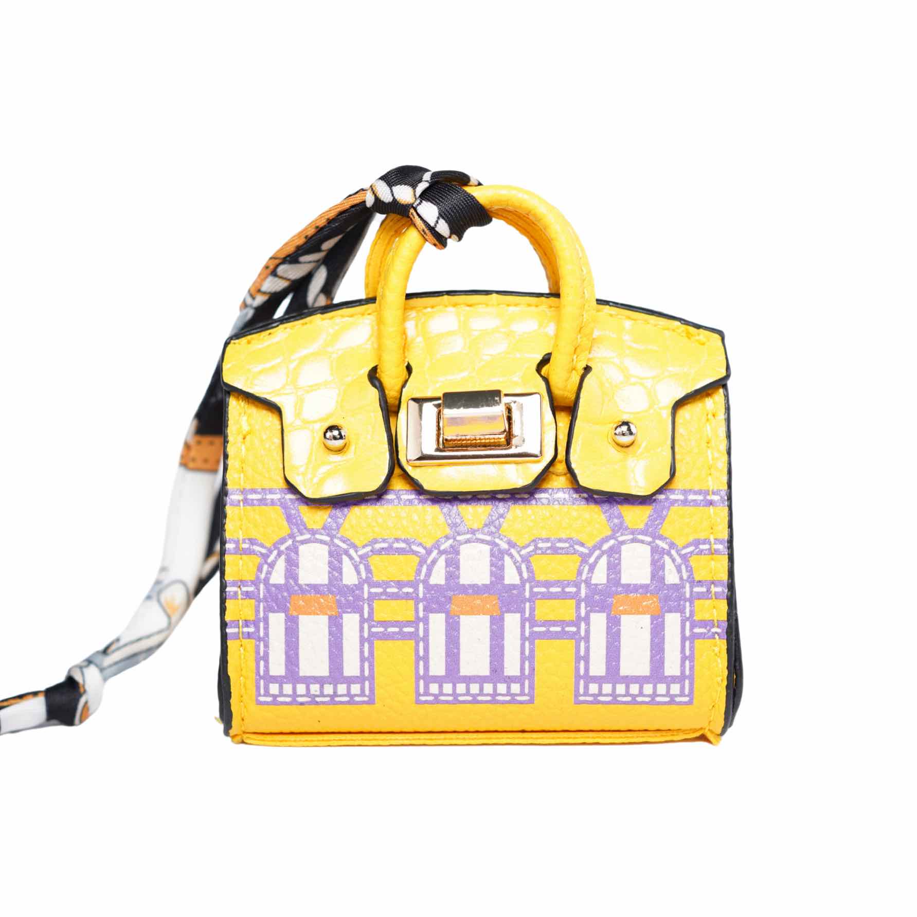 Yellow handbag-style dog waste bag dispenser with a patterned strap on a white background.