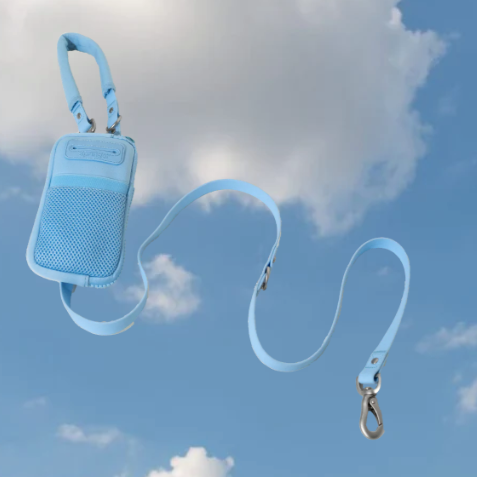 A light blue walk bag with dog leash on a sky background.
