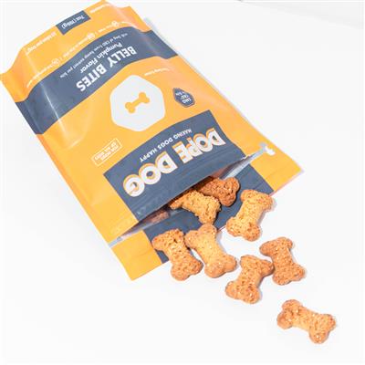 A yellow and gray pouch of Dope Dog's pumpkin flavored Belly Bites laying on its side with bone-shaped treats spilling out.