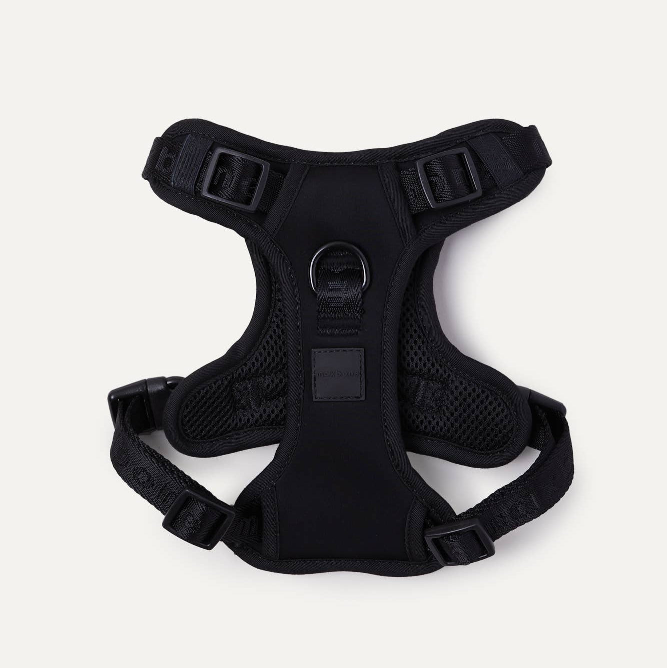 A black easy fit dog harness on a white background.