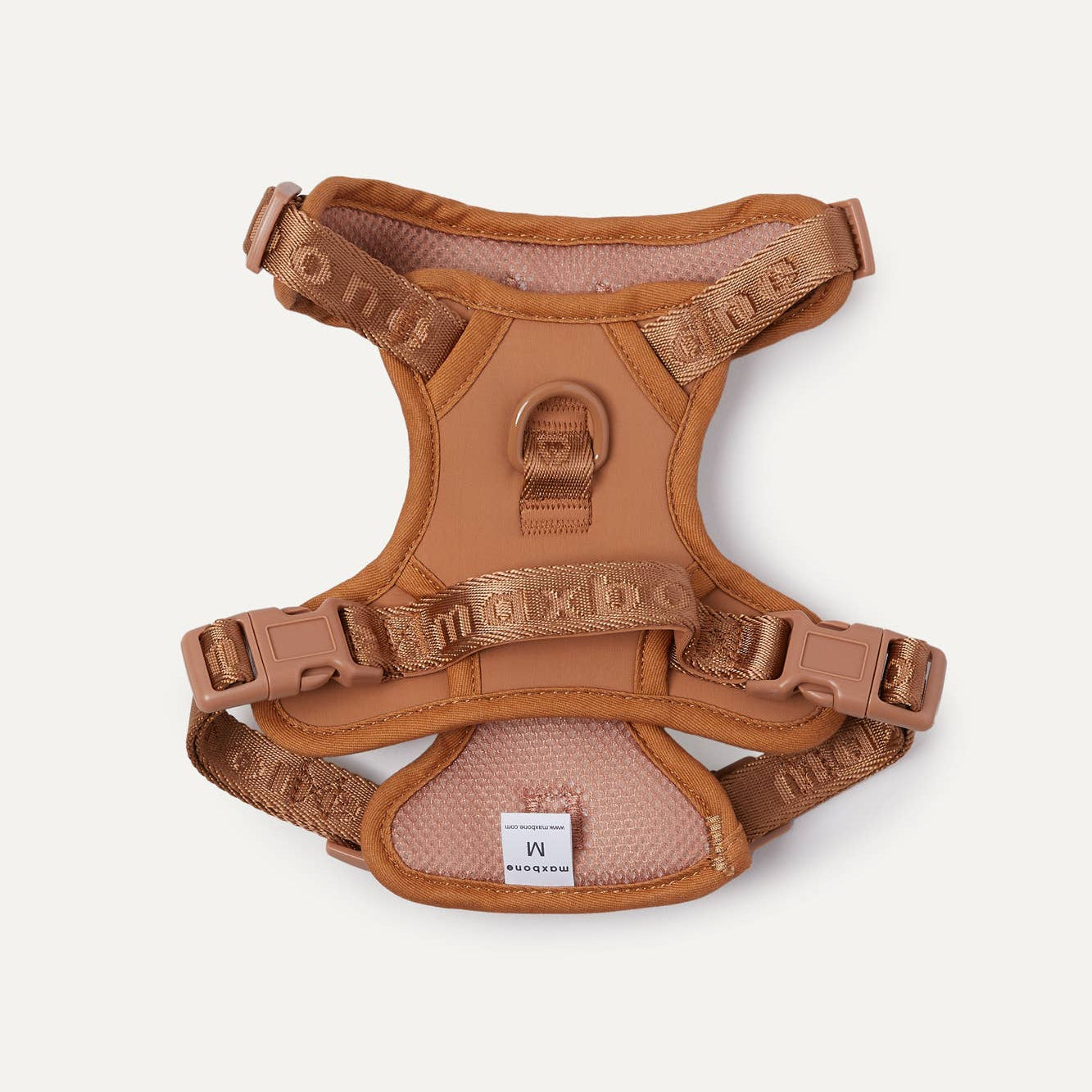 A camel colored dog harness.