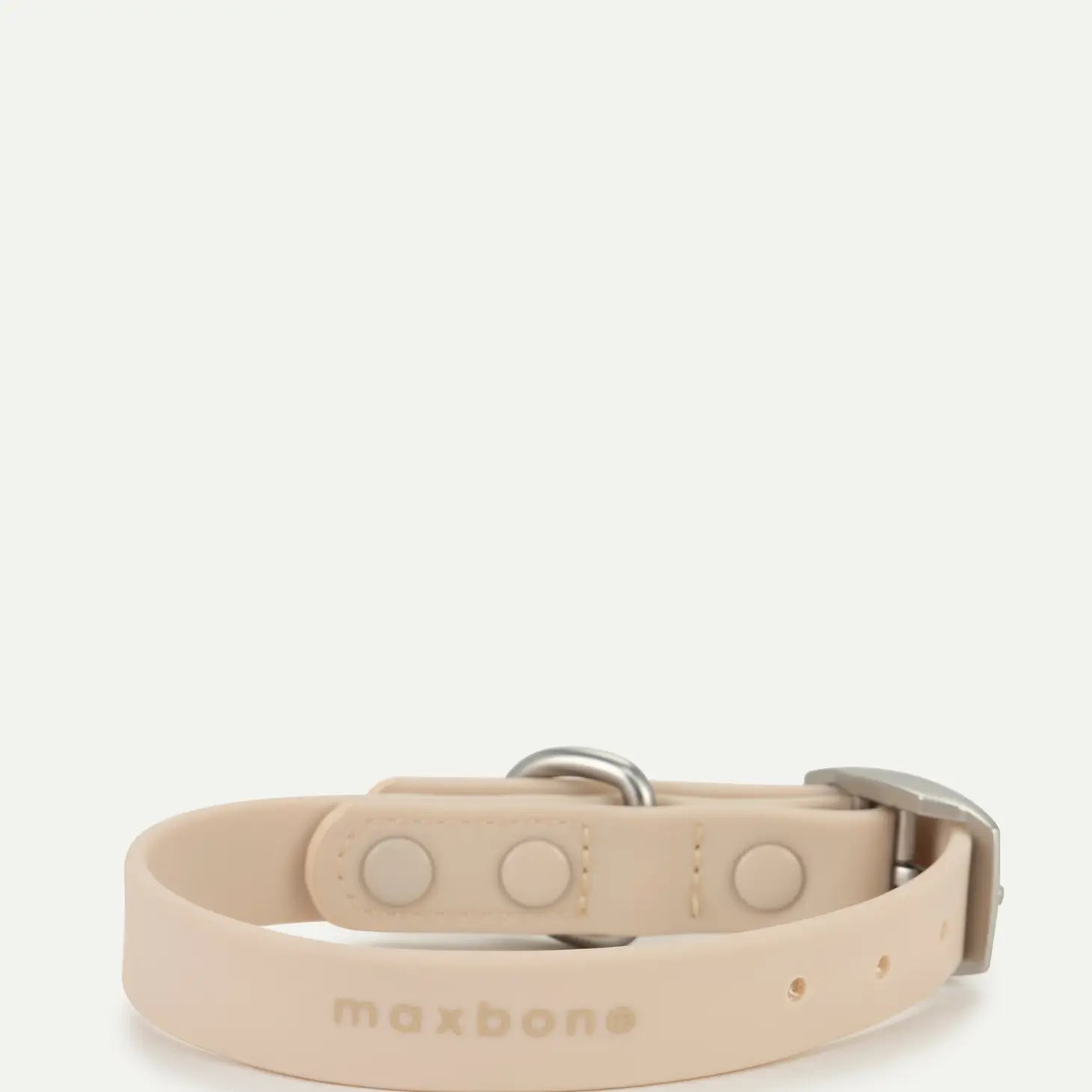 The other side of the sand-colored dog collar with silver hardware on a white background.