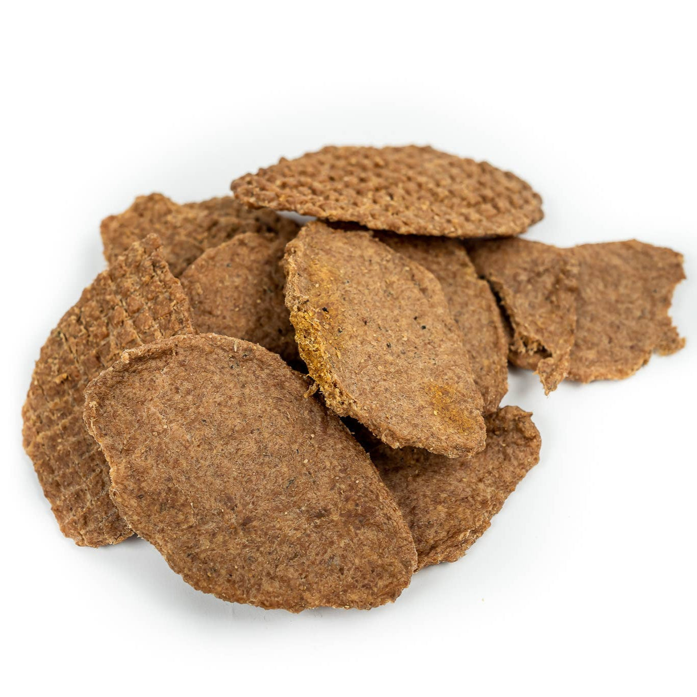 A pile of beige turkey jerkey pet treats on a white background.