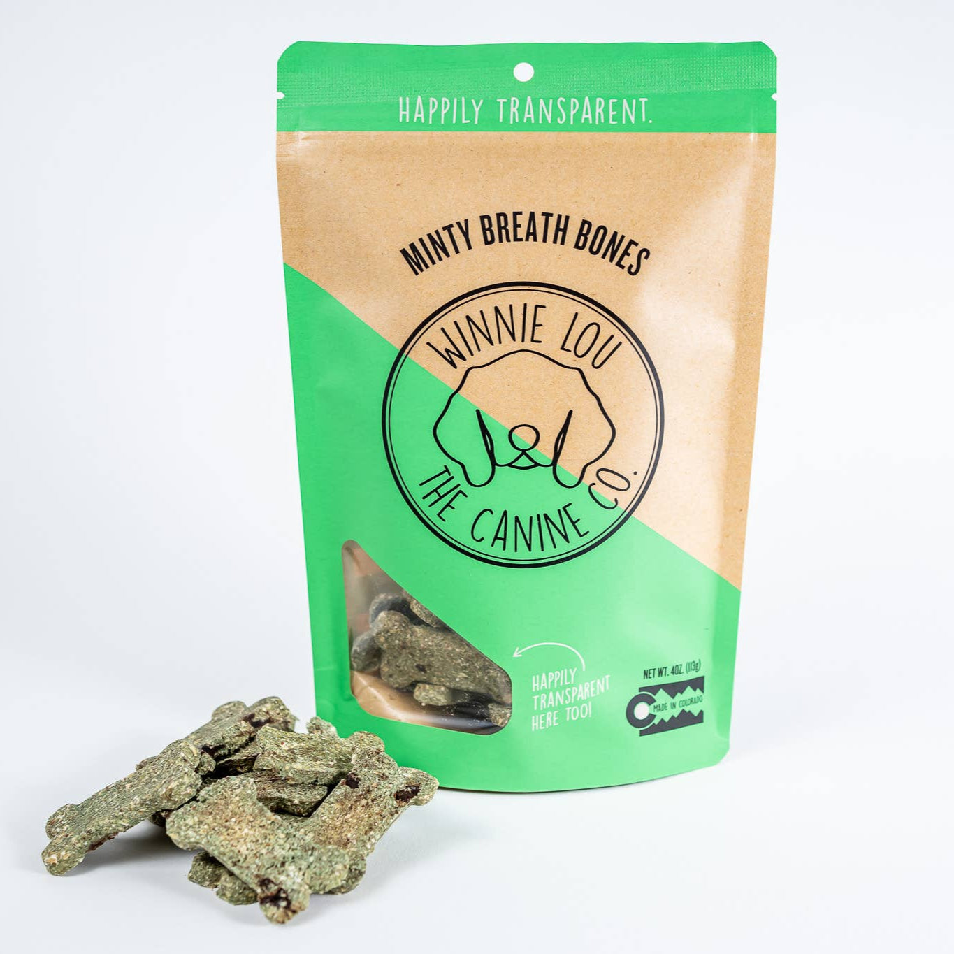 A green and beige pouch of minty breath bones with a small pile of the dog treats placed in front of it.