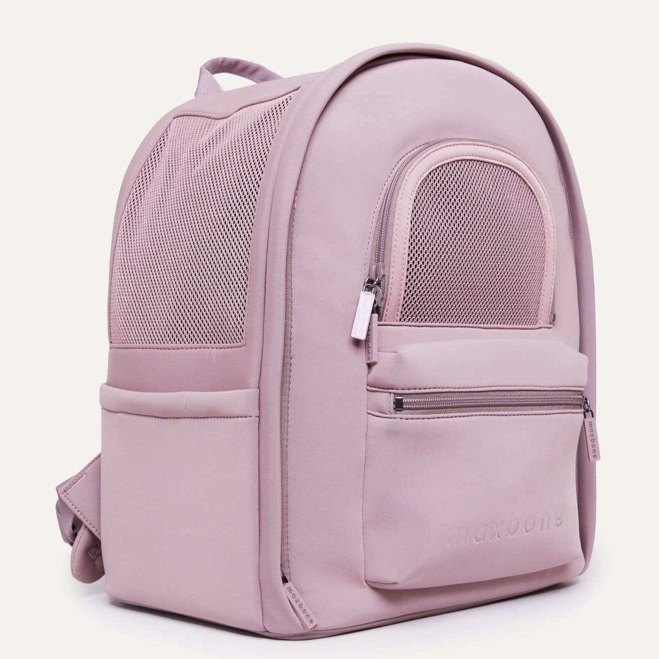A pink backpack-style dog carrier with mesh windows and multiple pockets.