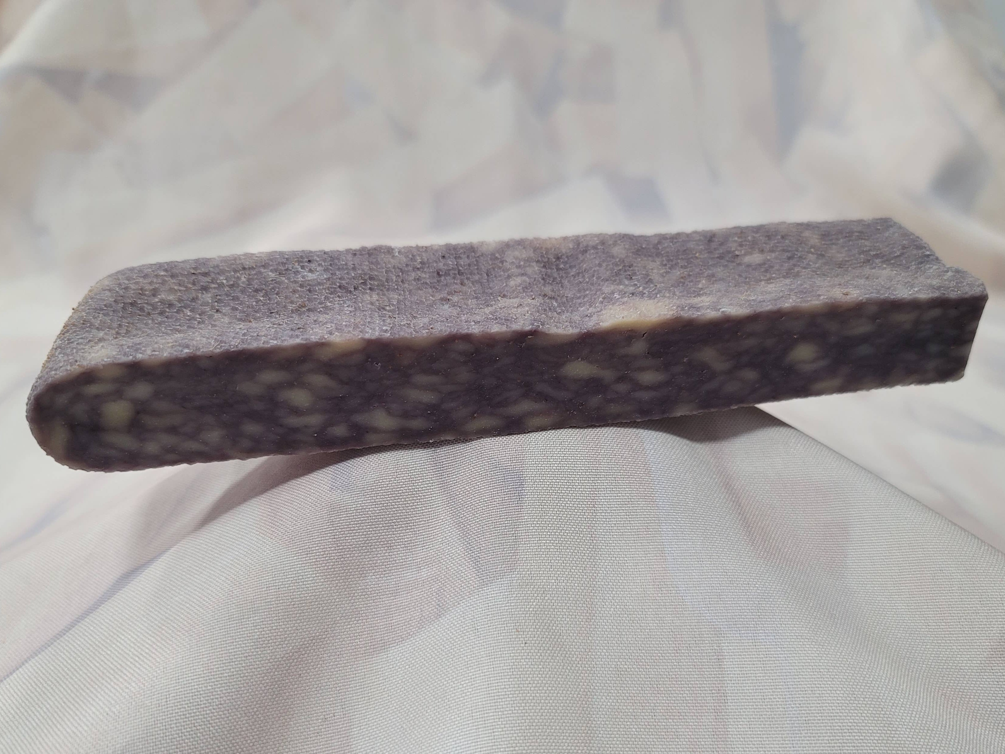 A blueberry, Himalayan-style cheese dog chew on a white cloth.