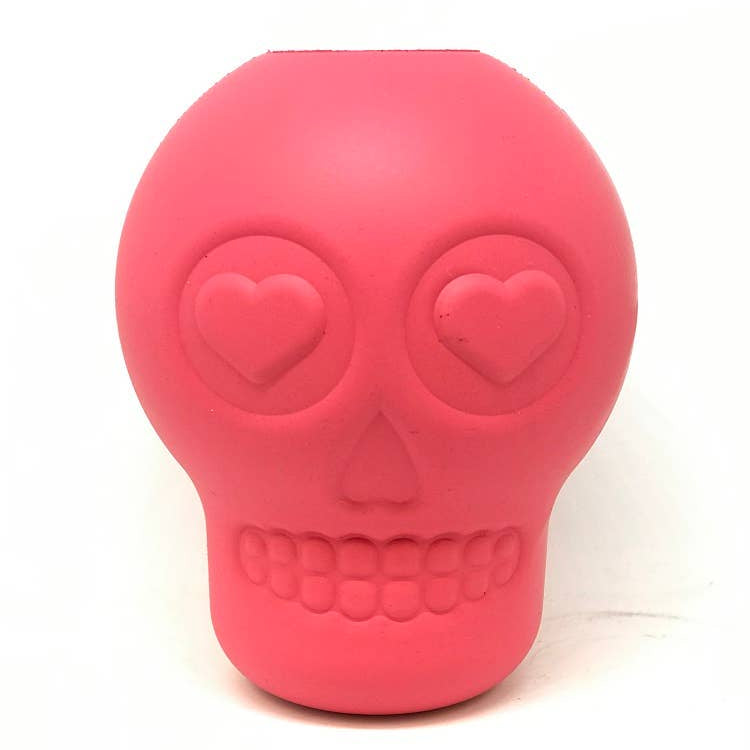 A red, skull-shaped dog chew toy and treat dispenser on a white background.