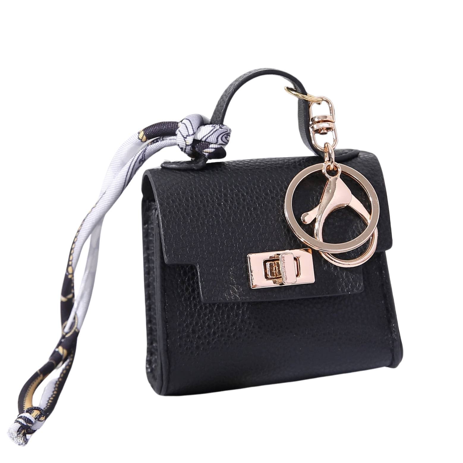 Black handbag-themed dog poop bag dispenser with a keychain on a white background.