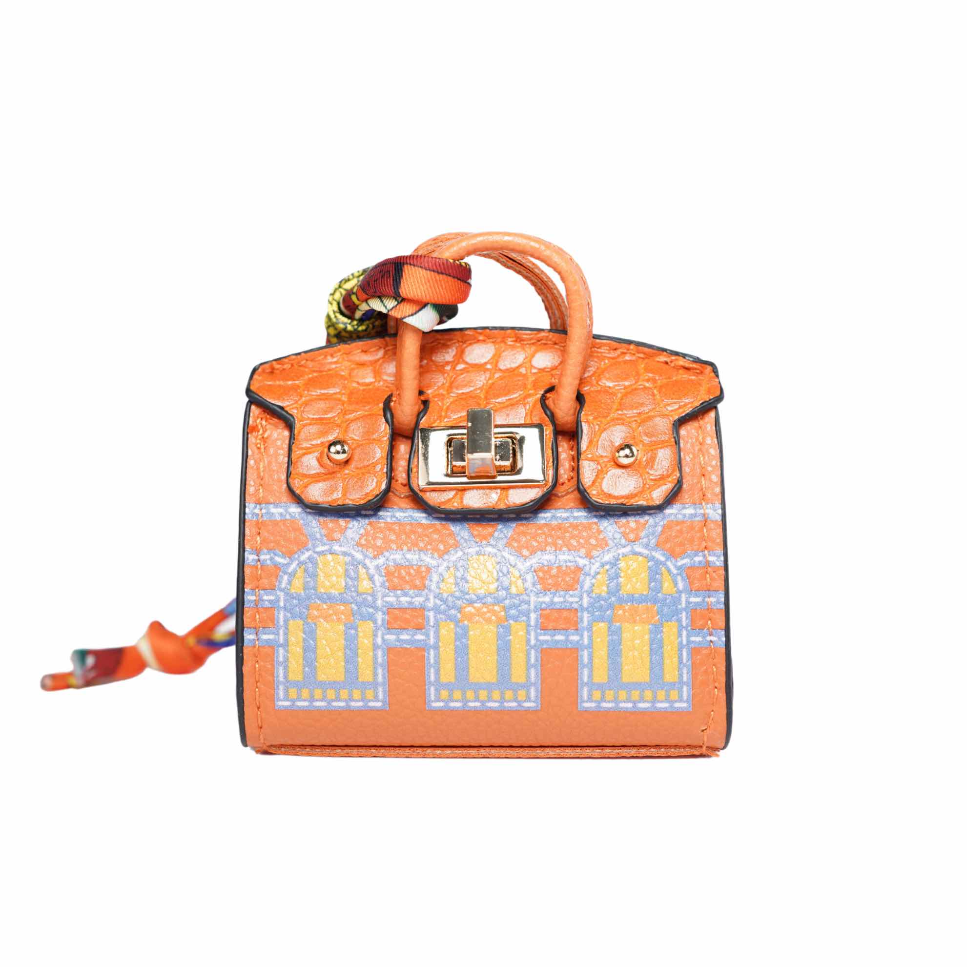 Orange handbag-style dog waste bag dispenser with architectural design on a white background.