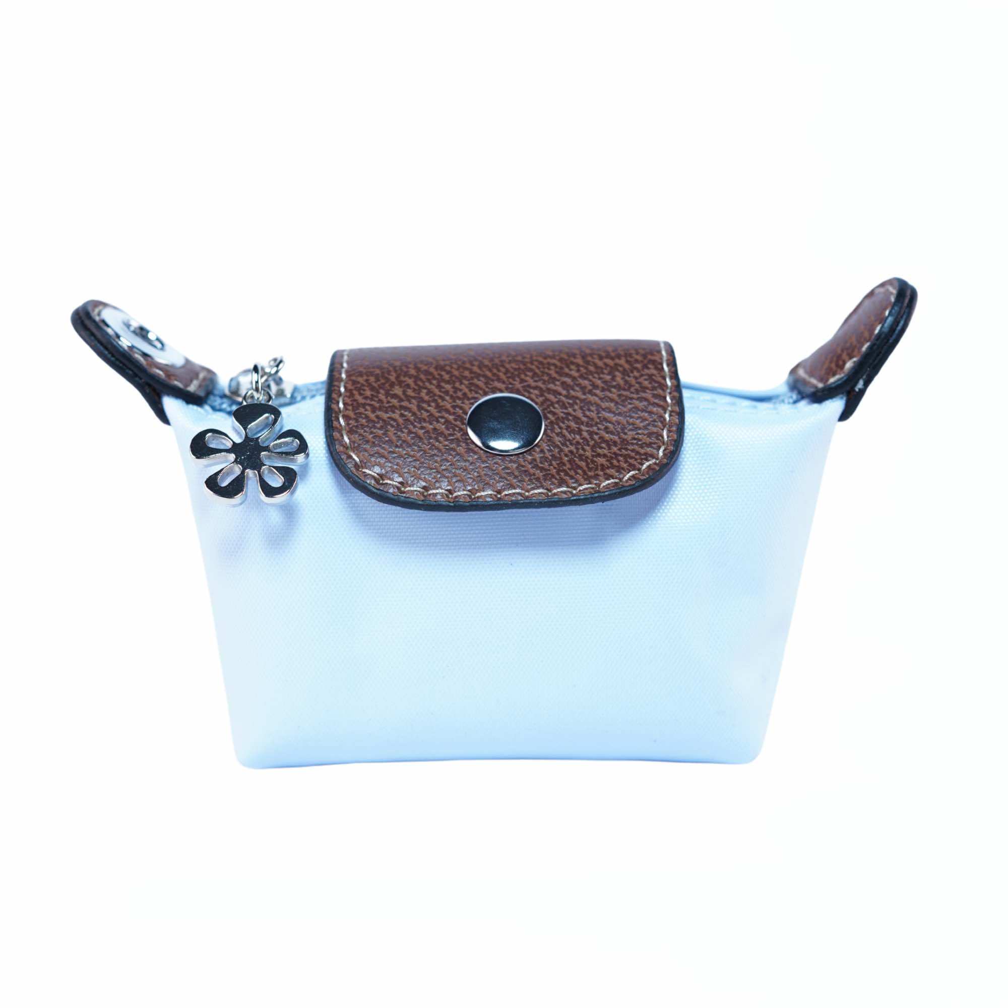 Small light blue dog waste bag pouch with brown leather flap and flower charm on a white background.