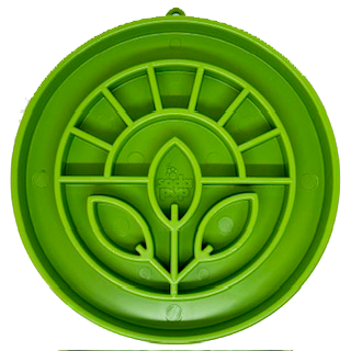 A round, green slow feeder tray with garden themed sections for food and treats.