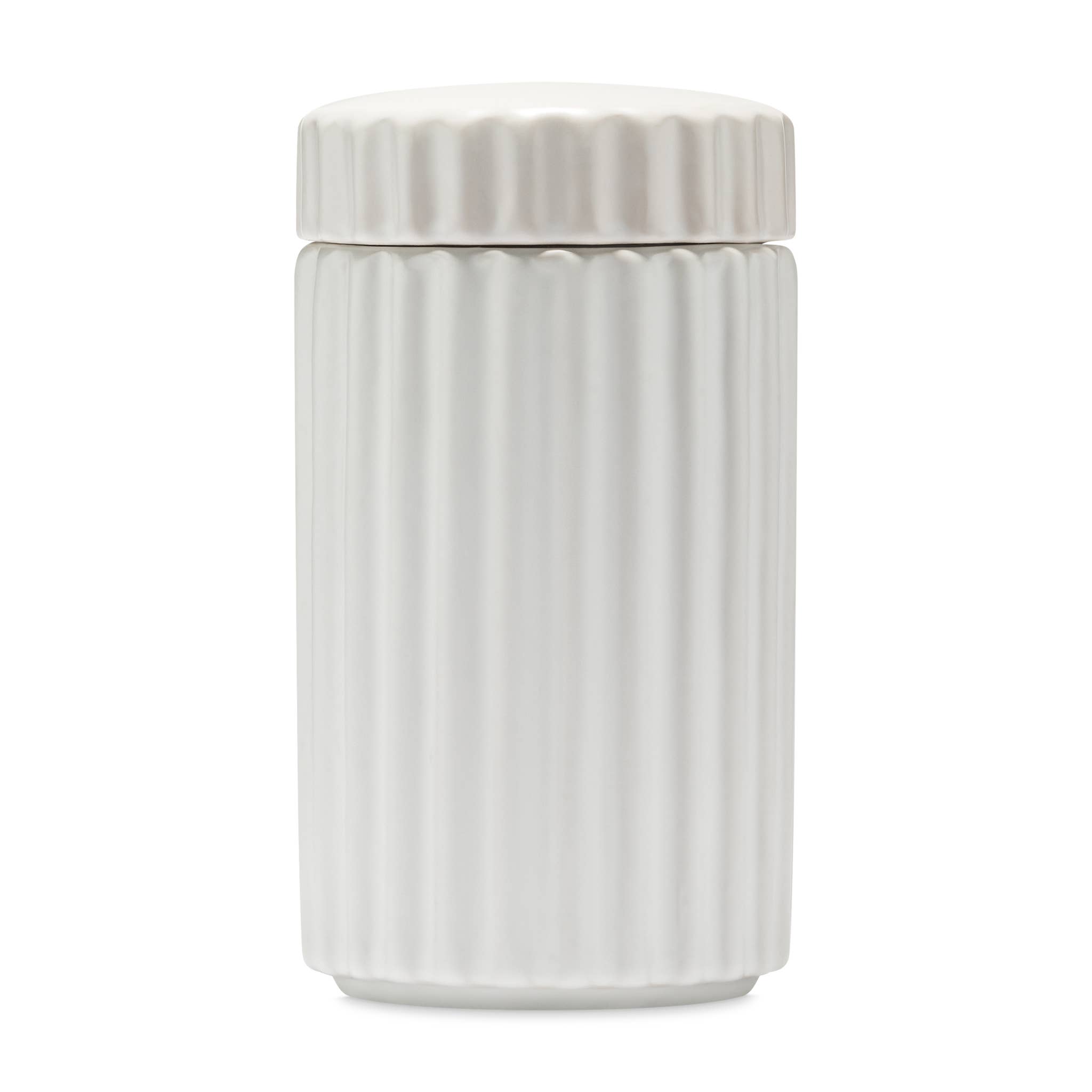 White, ceramic treat jar with vertical ridges and a snap-on lid on a white background.